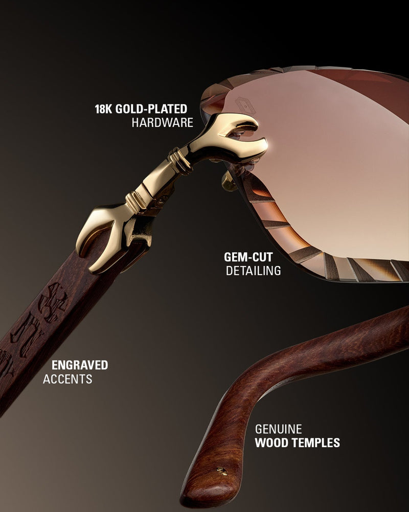 Luxury eyeglass frame with gold-plated hardware and engraved accents on a dark background